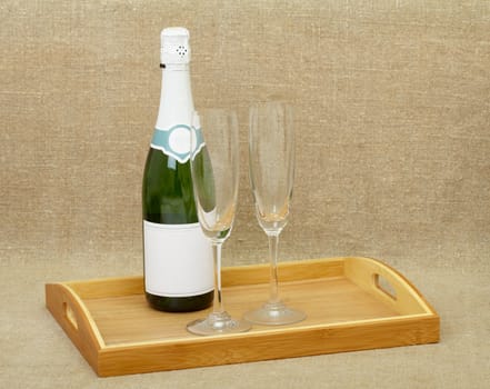 Champagne wine and two glasses on wooden tray