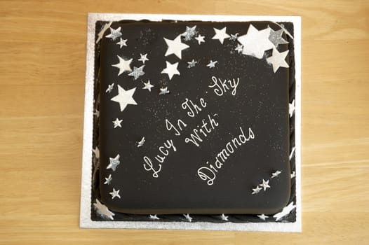 A black birthday cake on a table