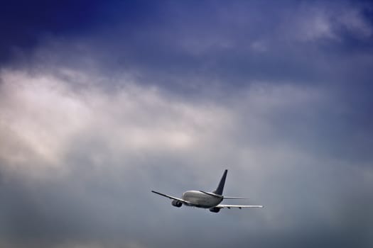 Jet airliner against stormy sky