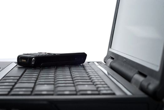 Cellular phone on a laptop