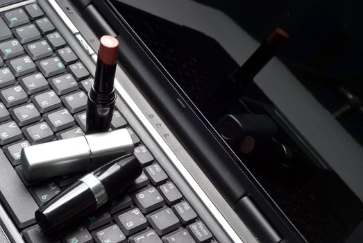three lipsticks on a laptop