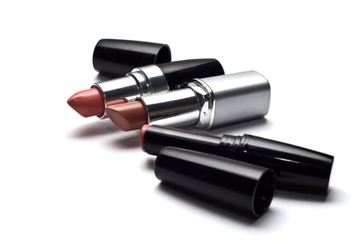 three lipsticks on a white background