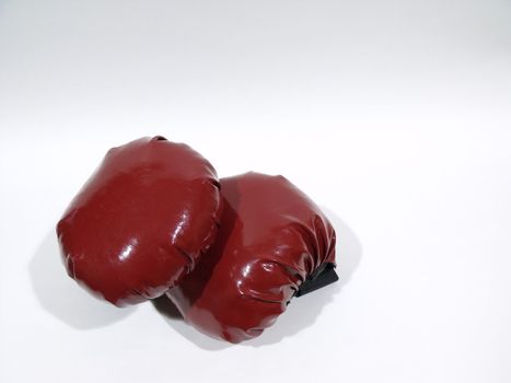 New red boxing gloves isolated on an arctic white surface