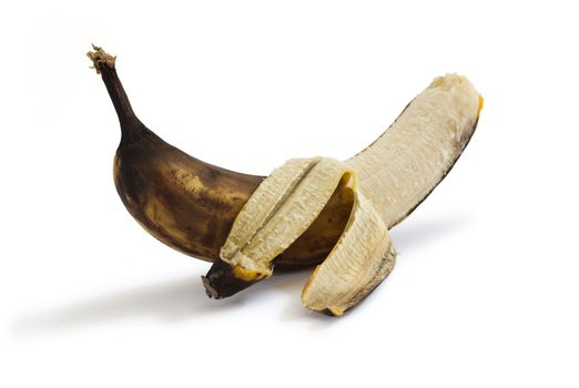 Peeled very ripe banana. Isolated on white background with shadows. Clipping path included to remove object shadow or replace background.