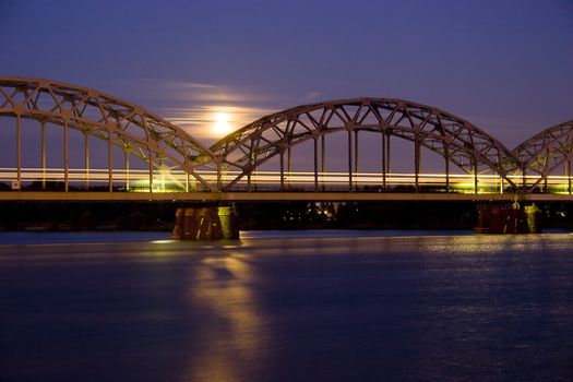 Night Train on Iron Bridge over river Daugava (Riga, Latvia, European Union, EU)