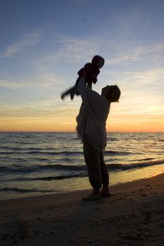 Mother and child playing in sunset