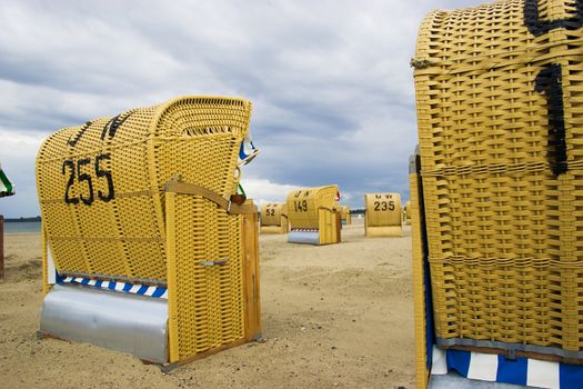 Beach wicker chairs with numbers on back in Germany near Baltic sea