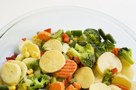 Frozen vegetables in glass dish ready for cooking