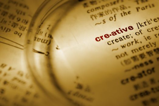 Focus on creative with magnifier on book.