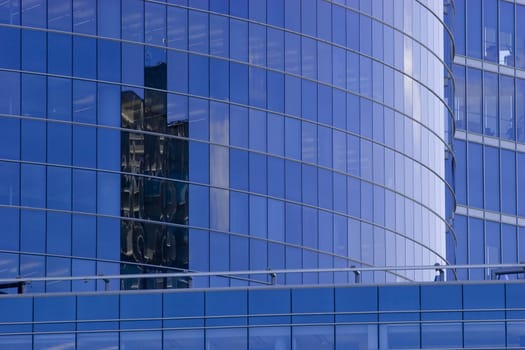 Corporate office building facade and reflection of other skyscraper