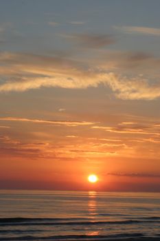 Sunset skies with clouds over sea