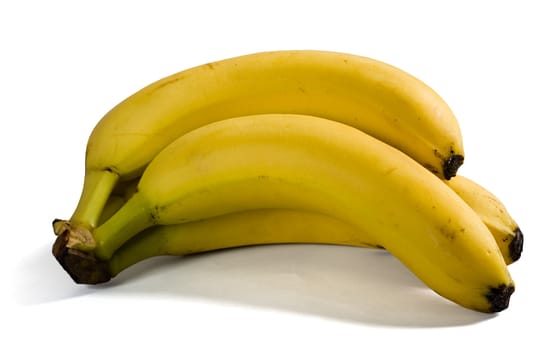 A bunch of three bananas with shadows on white background. Clipping path for bananas included