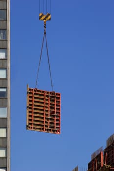 Hoisting concrete block. Building new skyscraper