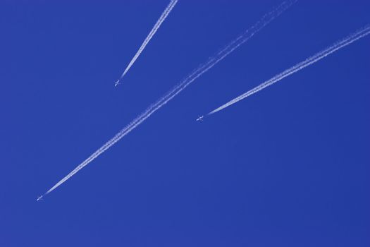Three Jet airplanes in blue sky. Aviation rush hour. Pilots dangerous game of speed.