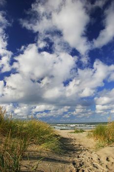 Trail to the sandy Beach via dunes covered with seagrass