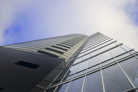 Office building Skyscraper on cloudy sky from low angle