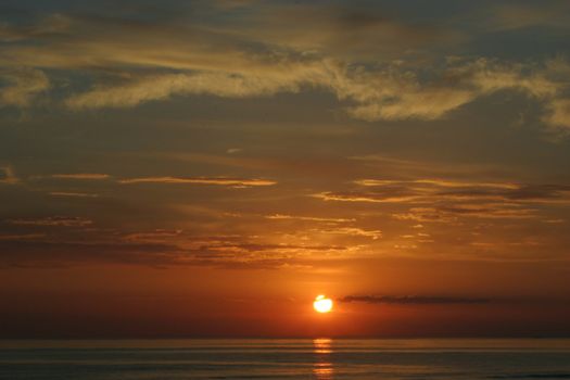 Sunset skies with clouds over sea