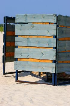 Green wooden beach cabine in sandy beach