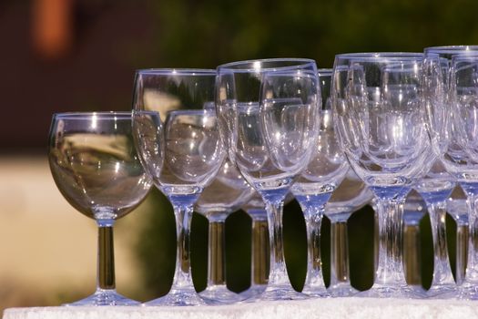 Arranged empty champagne (wine) glasses. Summer, outdoors.