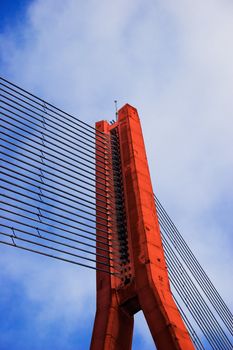 Modern Red Cable bridge closeup on blue sky