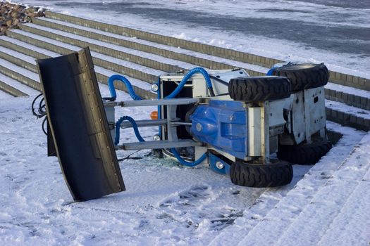 Crush of Small winter cleaning tractor (fliped on side. fallen from stears)