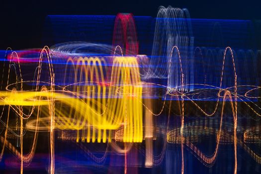 Colorful cardiogram of night city. Dancing lights of slow shutter speed