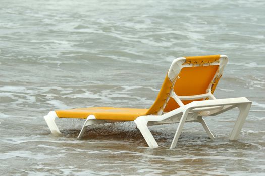 yellow chaise longue in water