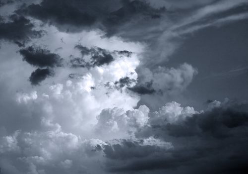 The image of white clouds on a background of the dark blue sky