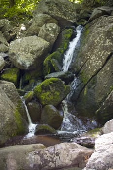 A beautiful waterfall flowing in the middle of the woods.