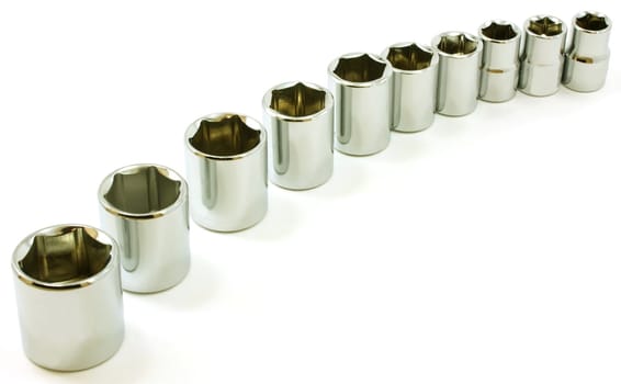 Chrome ratchet sockets in a curve, on white background