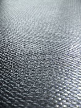Real carbon fiber in its raw form - this is the material that is used to make durable and strong parts for cars, boats, bikes and more. Shallow depth of field.