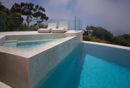 Custom Luxury Pool, Hot Tub and Chairs Abstract with Coastal Clouds in Background.