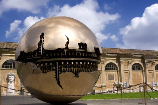 Golden ball in Vatican over blue sky