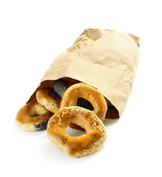 Fresh Montreal style bagels in paper bag on white background