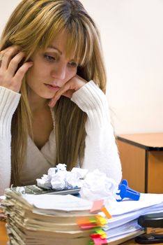 young businesswoman looking pile of documents and sheets