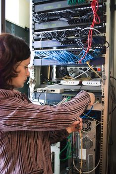 young woman repairs computer hardware