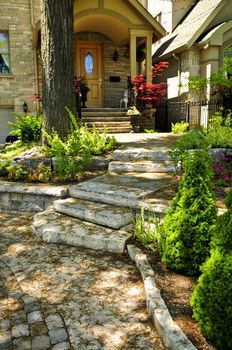 Landscaped front yard with natural stone steps and walkway