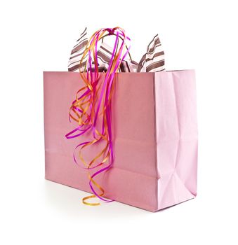 Pink shopping bag with ribbons isolated on white background