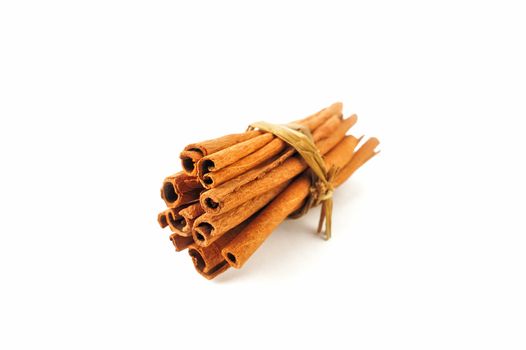 A bundle of dry cinnamon sticks on the white background