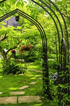 Lush green garden with wrought iron arbor