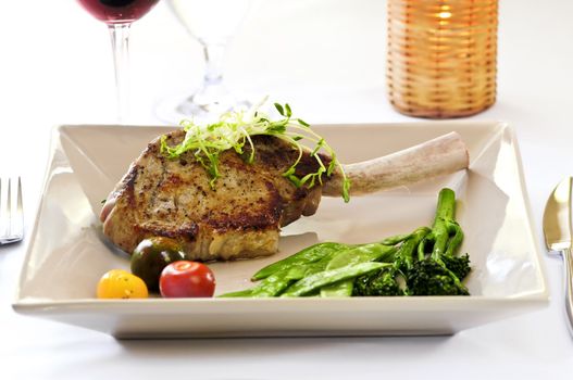 Gourmet dinner of veal rib chop and vegetables