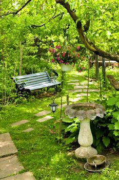 Path of stepping stones leading into lush green garden