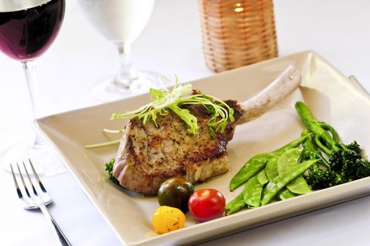 Gourmet dinner of veal rib chop and vegetables