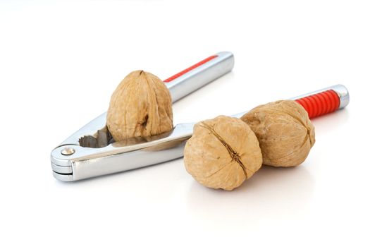 detail of nutcracker with three walnuts isolated on white background with clipping path