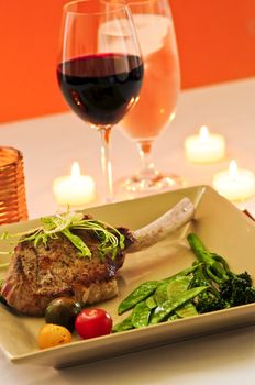 Gourmet romantic dinner with red wine at candlelight