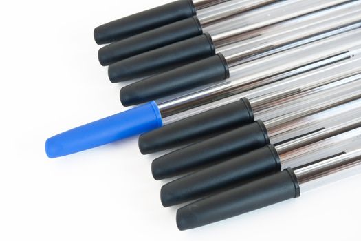 group of black pens with a blue one isolated on white background with clipping path