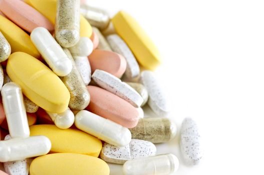 Mix of vitamins and herbal supplements on white background