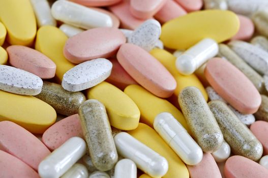 Mix of vitamins and herbal supplements close up