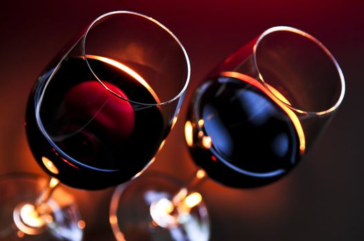 Two wineglasses with red wine at candlelight
