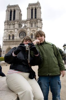 Family of mother and her son taking self portrait at the famous Cath�drale Notre-Dame de Paris